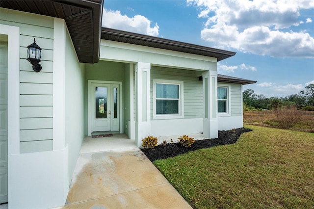 doorway to property with a yard