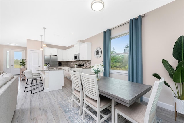 dining area featuring sink and light hardwood / wood-style flooring