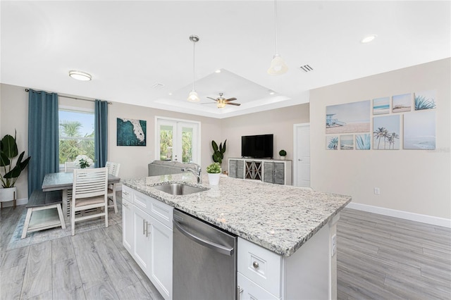 kitchen with sink, white cabinetry, hanging light fixtures, stainless steel dishwasher, and a raised ceiling