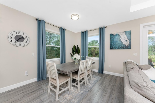 dining space with light hardwood / wood-style floors and a wealth of natural light