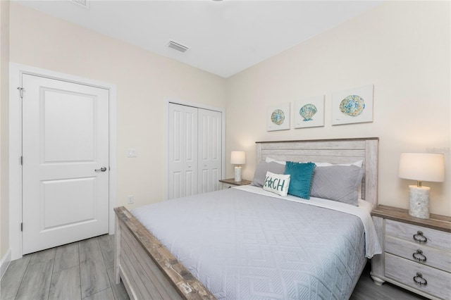 bedroom featuring hardwood / wood-style floors and a closet