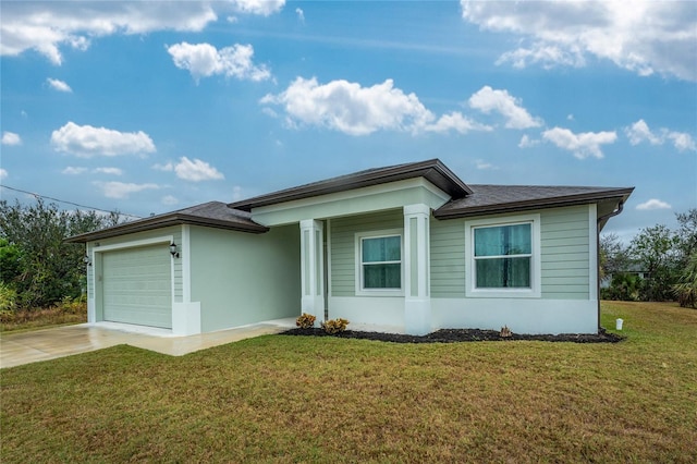 view of front of house with a garage and a front lawn