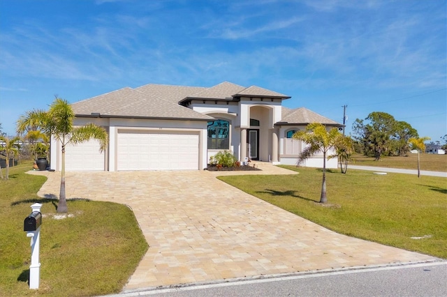 view of front of house featuring a garage and a front lawn