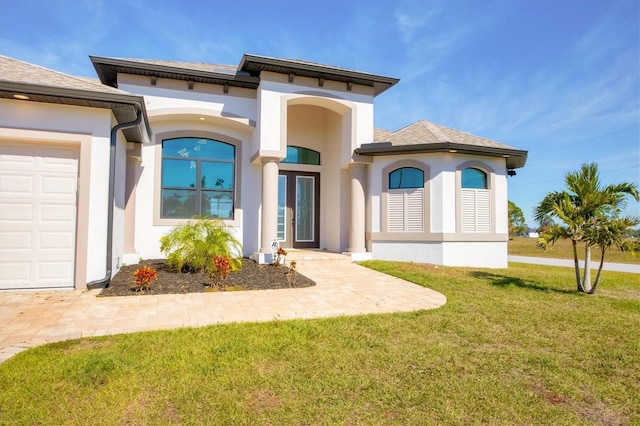 exterior space with a garage and a lawn