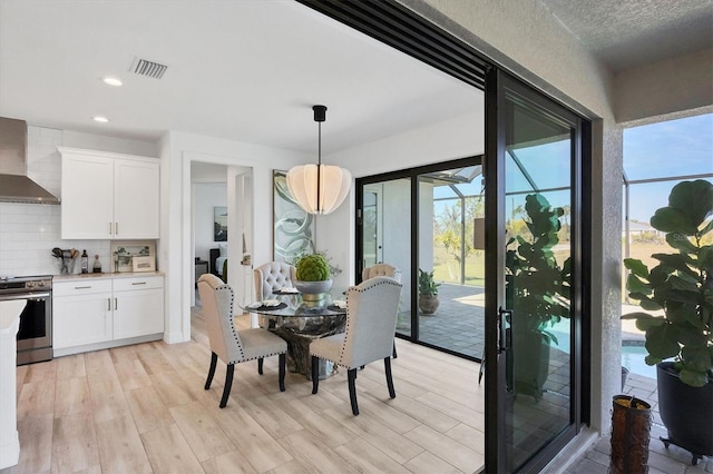 dining space featuring a healthy amount of sunlight and light wood-type flooring