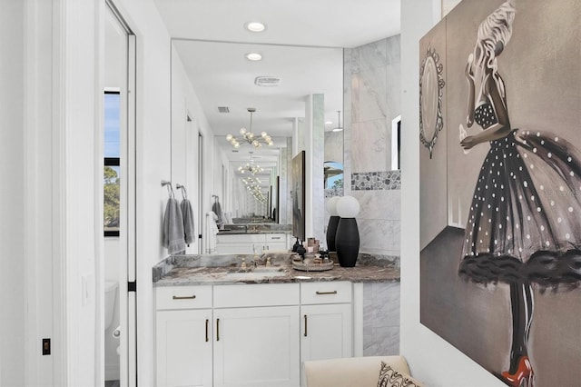 bathroom featuring vanity and a notable chandelier