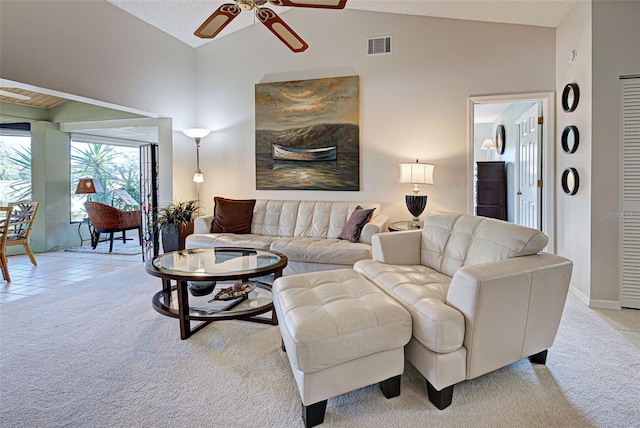 carpeted living room with high vaulted ceiling and ceiling fan