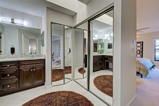 bathroom with vanity, tile patterned floors, and a textured ceiling