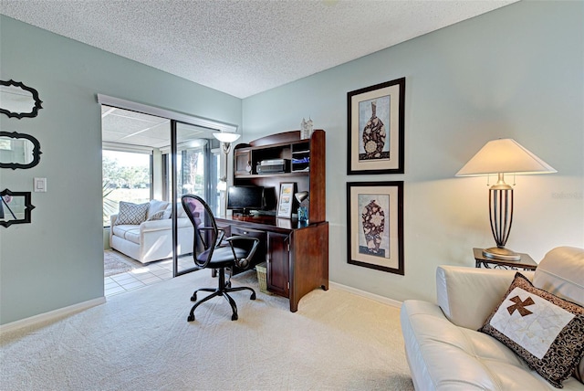 carpeted office space with a textured ceiling