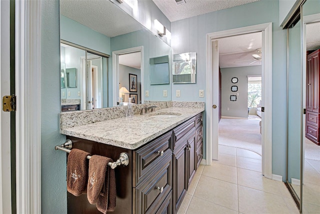 bathroom with vanity, tile patterned floors, and a textured ceiling