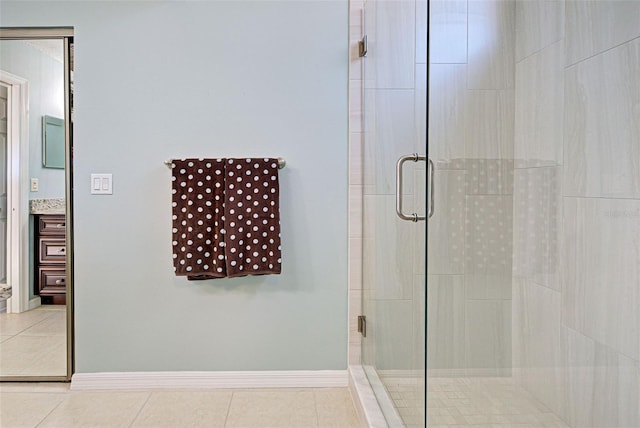 bathroom featuring vanity, tile patterned floors, and walk in shower