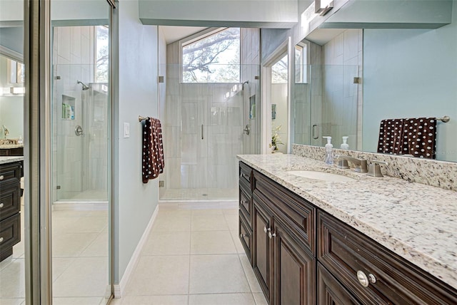 bathroom with vanity, a shower with shower door, and tile patterned flooring