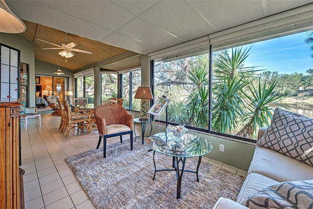 sunroom / solarium with ceiling fan, lofted ceiling, and a healthy amount of sunlight