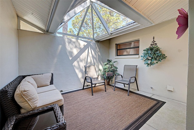 view of patio with glass enclosure