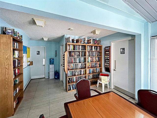 unfurnished office with tile patterned floors and a textured ceiling