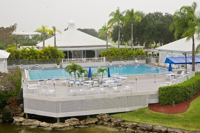 view of swimming pool featuring a deck with water view