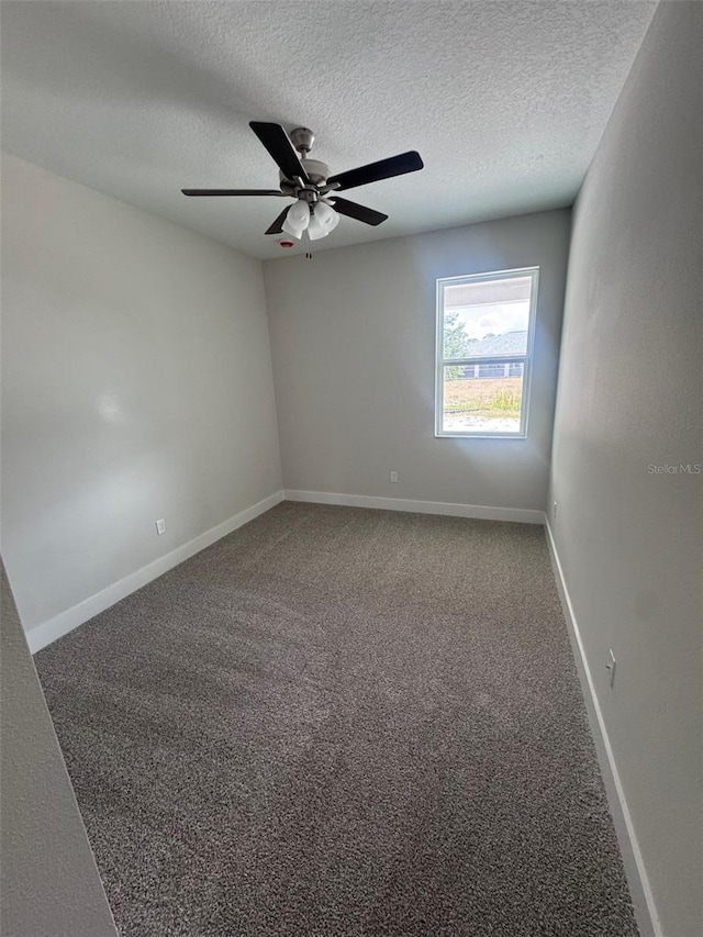 empty room with carpet, a textured ceiling, a ceiling fan, and baseboards