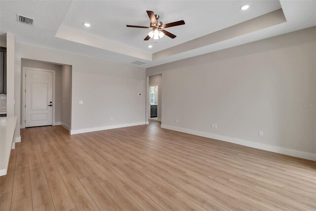 2814 Vogler Ln, North Port, FL 34286 - unfurnished room featuring a raised ceiling, a ceiling fan, light wood-style floors, and recessed lighting