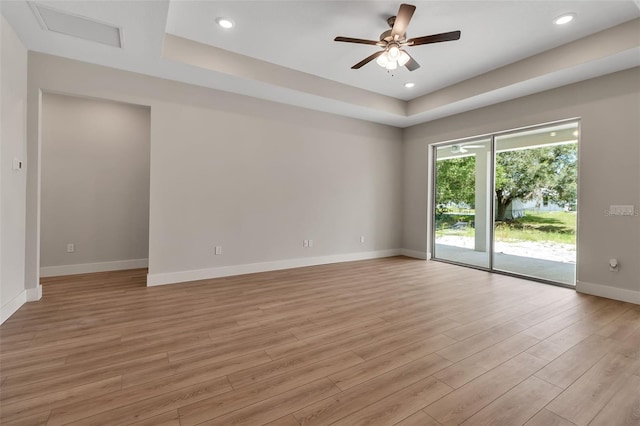 2814 Vogler Ln, North Port, FL 34286 - empty room featuring a tray ceiling, light wood-style floors, a ceiling fan, and recessed lighting