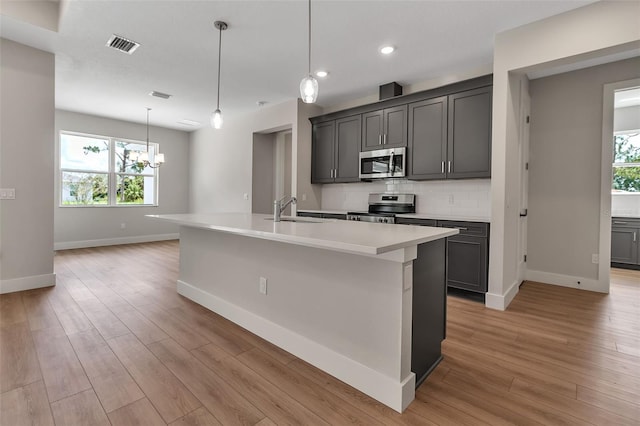 2814 Vogler Ln, North Port, FL 34286 - kitchen featuring stainless steel appliances, a chandelier, healthy amount of natural light, light countertops, and recessed lighting