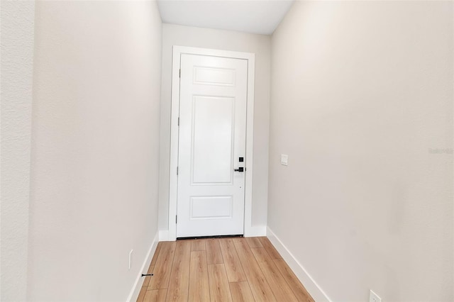 2814 Vogler Ln, North Port, FL 34286 - doorway to outside with light wood finished floors and baseboards
