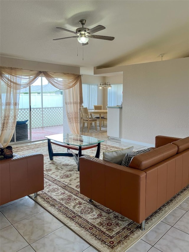 living room featuring light tile patterned flooring, a wealth of natural light, and ceiling fan