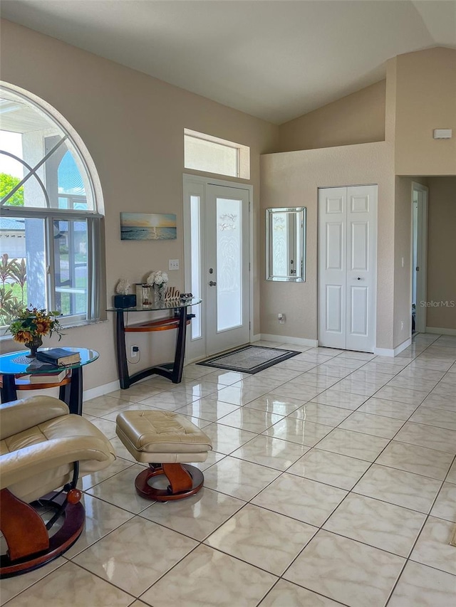 tiled entryway with vaulted ceiling