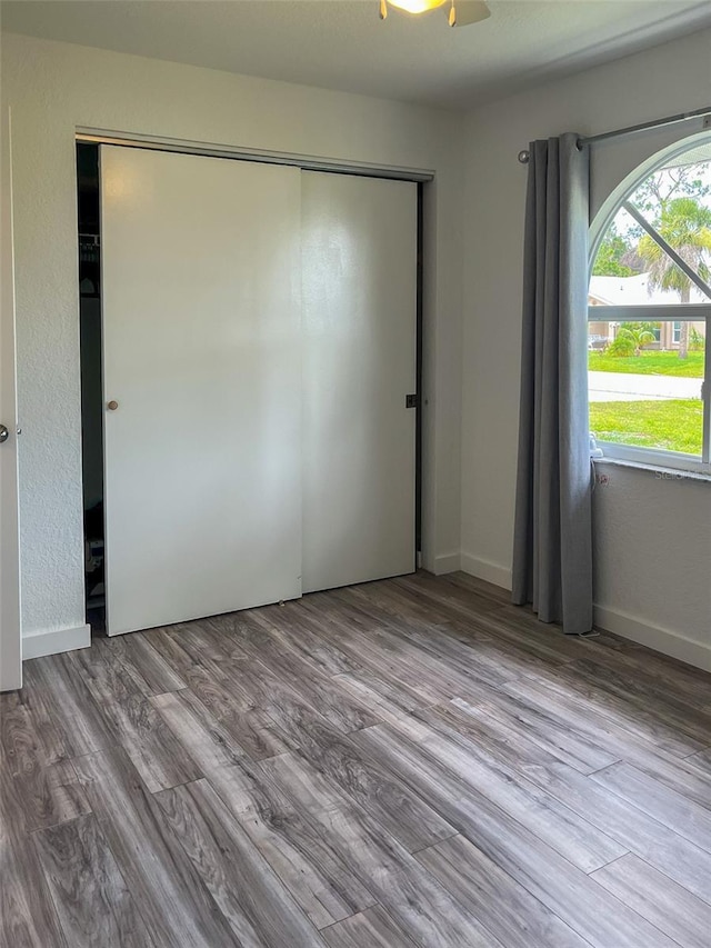 unfurnished bedroom featuring light hardwood / wood-style flooring and a closet