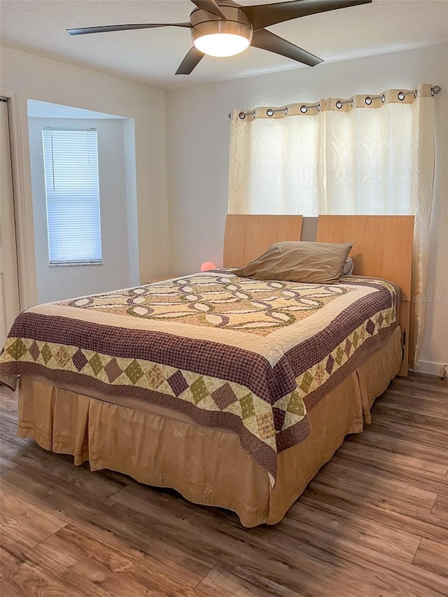 bedroom featuring hardwood / wood-style flooring and ceiling fan