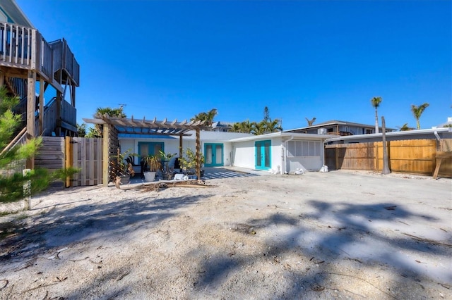 back of property with french doors and a pergola