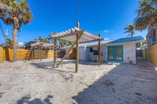 back of property with french doors and a pergola