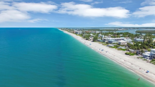 drone / aerial view with a beach view and a water view