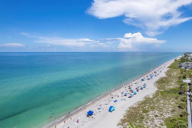 birds eye view of property with a beach view and a water view