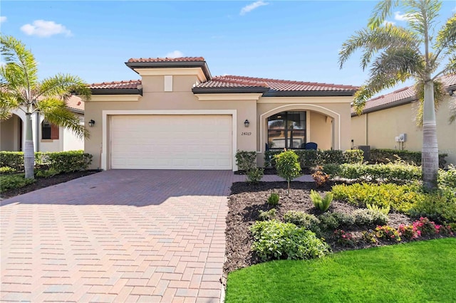 mediterranean / spanish home featuring a garage