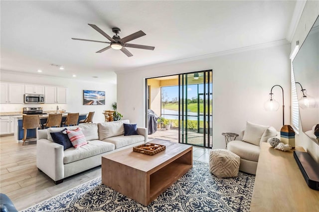 24269 Spartina Dr, Venice, FL 34293 - living room featuring crown molding, ceiling fan, and light hardwood / wood-style flooring