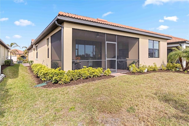24269 Spartina Dr, Venice, FL 34293 - back of house with a lawn and a sunroom
