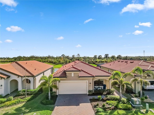 24269 Spartina Dr, Venice, FL 34293 - mediterranean / spanish house with a garage and a front lawn