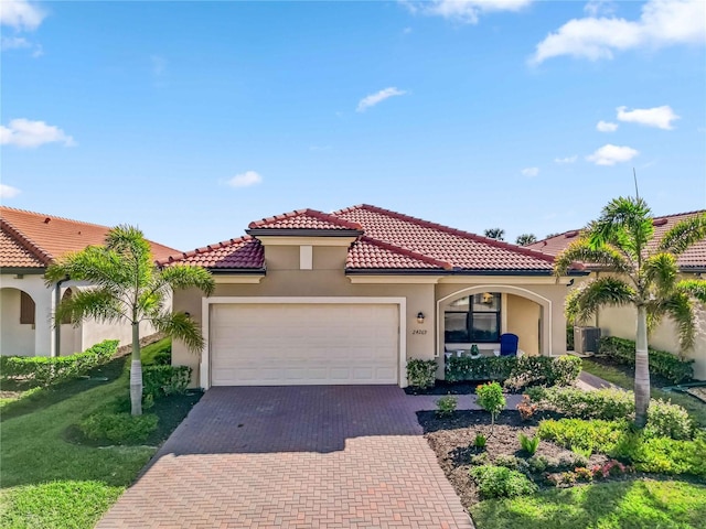 24269 Spartina Dr, Venice, FL 34293 - mediterranean / spanish house with a garage and central AC unit