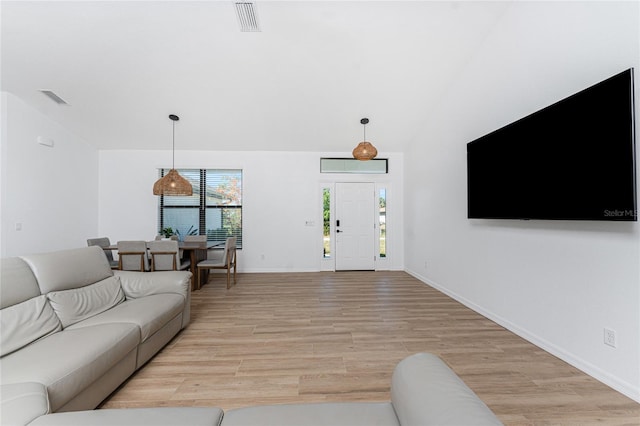 living room with lofted ceiling and light hardwood / wood-style flooring