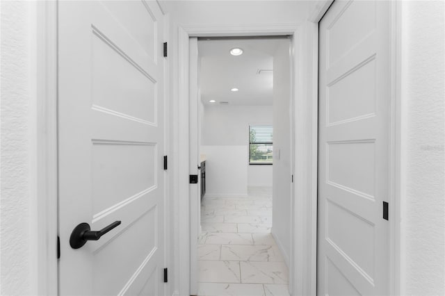 hallway featuring recessed lighting and marble finish floor