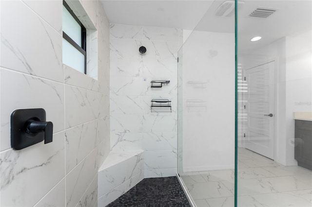 bathroom featuring vanity and tiled shower