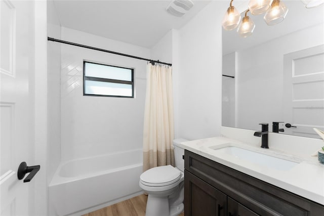 full bath with visible vents, toilet, wood finished floors, shower / bath combination with curtain, and vanity