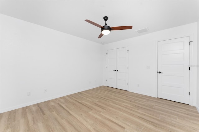 unfurnished bedroom with ceiling fan and light wood-type flooring