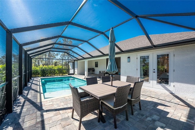 view of swimming pool featuring french doors, glass enclosure, and a patio