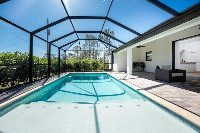 view of swimming pool featuring an outdoor hangout area, a lanai, a patio area, and ceiling fan