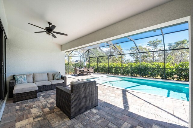 view of pool featuring a ceiling fan, a patio, outdoor lounge area, a fenced in pool, and a lanai