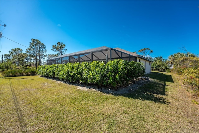 view of yard with glass enclosure and a garage