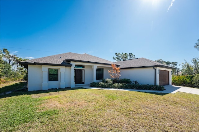 view of front of house with a garage and a front lawn