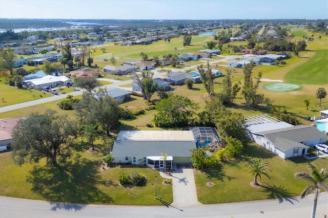 drone / aerial view with view of golf course and a residential view