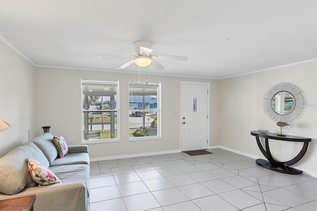 foyer with light tile patterned floors, a textured ceiling, a ceiling fan, baseboards, and ornamental molding